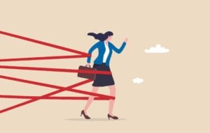 Business woman trying to run through red tape